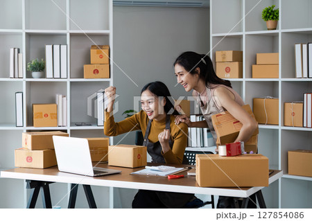 Business Ecommerce success, Female online store owners giving each other a high five in celebration 127854086