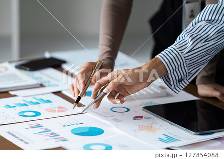 Group of business people meeting together Pointing to the graph assess business profits 127854088