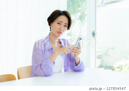 スマホを持って考える女性 127854547