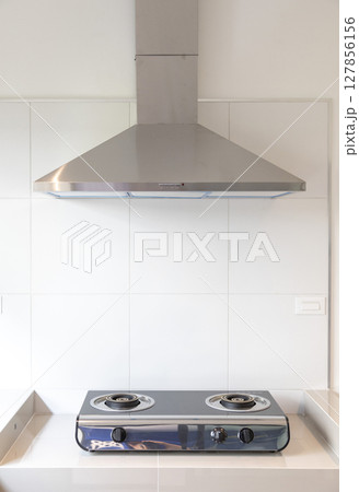 cooking gas stove with hood in modern kitchen 127856156