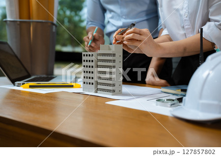 architect or engineer team working on table use drawing tool on the paper plan for business architectural project. architect or engineer team working on table use drawing tool on the paper plan for business architectural project. 127857802