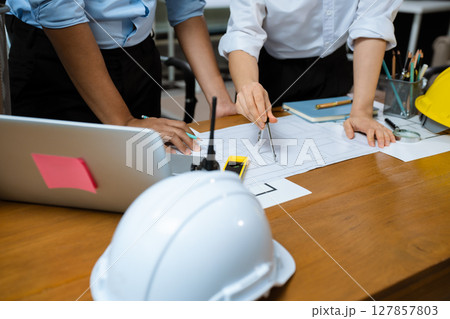 architect or engineer team working on table use drawing tool on the paper plan for business architectural project. architect or engineer team working on table use drawing tool on the paper plan for business architectural project. 127857803