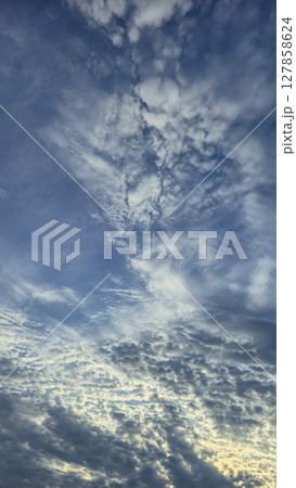 Dark blue sky with clouds over trees and water surface. Evening sunset. Dark blue sky with clouds over trees and water surface. Evening sunset. 127858624