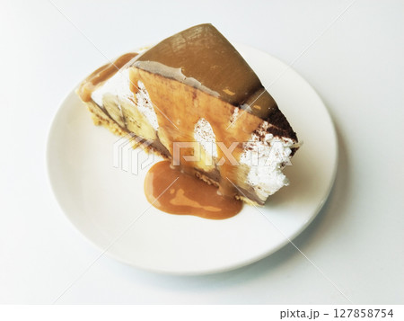 Caramel Banoffee cake on white dish and background 127858754