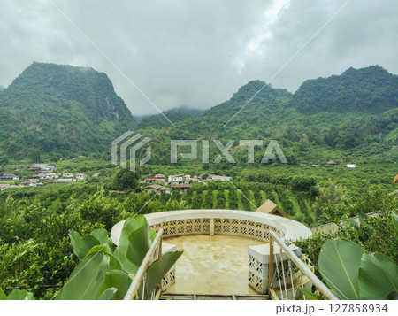 A circular viewpoint in the garden overlooks the lush mountain peaks. A circular viewpoint in the garden overlooks the lush mountain peaks. 127858934
