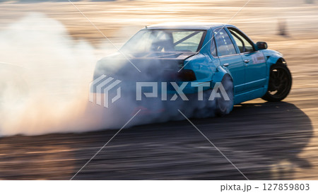 Car drifting, Blurred image diffusion race drift car with lots of smoke from burning tires on speed track, Car drifting on speed track. Car drifting, Blurred image diffusion race drift car with lots of smoke from burning tires on speed track, Car drifting on speed track. 127859803