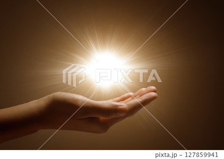A hand holding a light up to the camera A hand holding a light up to the camera 127859941
