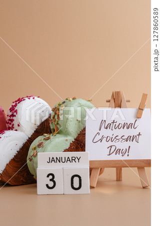 International croissant day saying caption on greeting card Delightful heartshaped pastry croissant treat, beautifully topped with colorful frosting galore. Copy space. Food experimentation viral 127860589