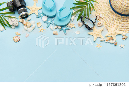 Summer accessories creating a frame on light blue background with copy space Summer accessories creating a frame on light blue background with copy space 127861201