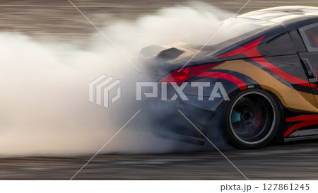 Car drifting, Blurred image diffusion race drift car with lots of smoke from burning tires on speed track, Car drifting on speed track, Professional driver driv drifting car. Car drifting, Blurred image diffusion race drift car with lots of smoke from burning tires on speed track, Car drifting on speed track, Professional driver driv drifting car. 127861245