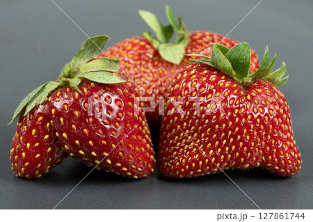 Fresh strawberries with an unusual shape close-up Fresh strawberries with an unusual shape close-up 127861744