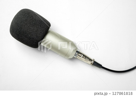 Studio microphone for podcasting or streaming with connected cable on a white background. Top view Studio microphone for podcasting or streaming with connected cable on a white background. Top view 127861818