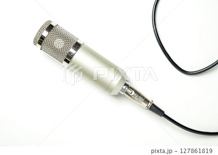 Studio microphone for podcasting or streaming with connected cable on a white background. Top view Studio microphone for podcasting or streaming with connected cable on a white background. Top view 127861819
