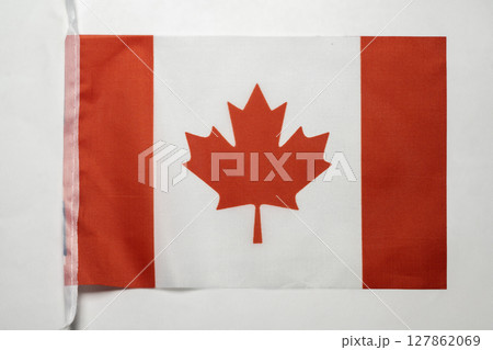 Closeup view of the Canada national flag isolated over a white background. Concept of government and nationality Closeup view of the Canada national flag isolated over a white background. Concept of government and nationality 127862069