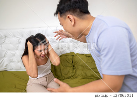 Indonesian southeast asian couple have an argument in the bedroom. Having a crisis and difficulties in a relationship Indonesian southeast asian couple have an argument in the bedroom. Having a crisis and difficulties in a relationship 127863011