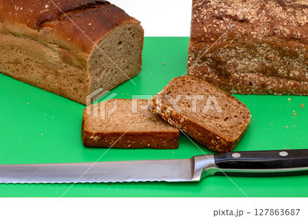 Dark whole grain rye bread with knife Dark whole grain rye bread with knife 127863687