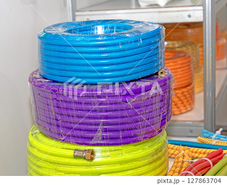 Colorful plastic hoses pile 127863704