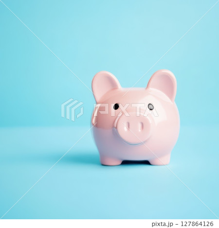 Cute pink piggy bank on a blue background 127864126
