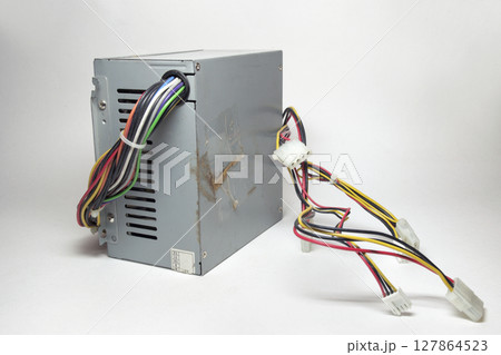 computer ATX power supply unit front side with ventilation holes. colorful power cords for conneting to drives are directly from non-modular case 127864523