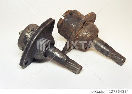 car ball joints pair. suspension component: threaded axis with ball bearing in metal socket with three mounting holes, old. on white background car ball joints pair. suspension component: threaded axis with ball bearing in metal socket with three mounting holes, old. on white background 127864554