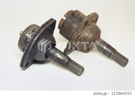 car ball joints pair. suspension component: threaded axis with ball bearing in metal socket with three mounting holes, old. on white background 127864555