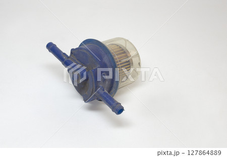 fuel filter, in-line, replaceable, with clogs up paper filter media, maintenance needs, replace, on white background, with clipping path fuel filter, in-line, replaceable, with clogs up paper filter media, maintenance needs, replace, on white background, with clipping path 127864889