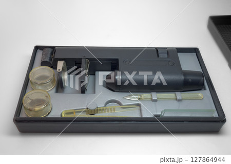 monocular microscope in portable case for storing with tools and asseseories. with clipping path 127864944