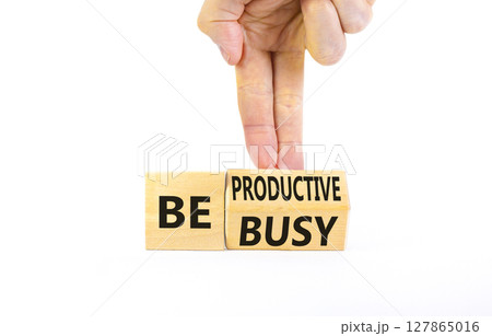 Be productive not busy symbol. Concept words Be productive Be busy on wooden block. Beautiful white table white background. Businessman hand. Business be productive not busy concept. Copy space. 127865016