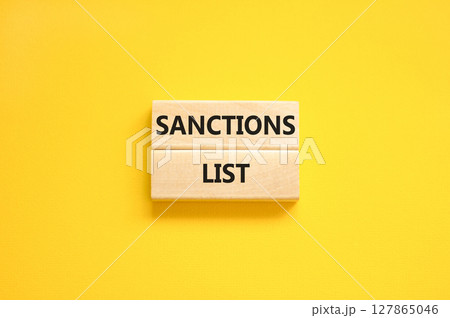 Sanctions list symbol. Wooden blocks with concept words Sanctions list on beautiful yellow background. Business political sanctions list concept. Copy space. 127865046