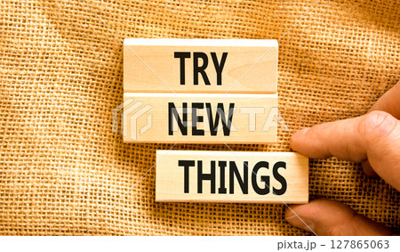 Try new things symbol. Concept words Try new things on beautiful wooden block. Businessman's hand. Beautiful canvas background. Business motivational lifestyle try new things concept. Copy space. Try new things symbol. Concept words Try new things on beautiful wooden block. Businessman's hand. Beautiful canvas background. Business motivational lifestyle try new things concept. Copy space. 127865063