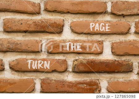 Turn the page symbol. Concept words Turn the page on beautiful brown brick wall. Beautiful brown brick wall background. Business motivational lifestyle turn the page concept. Copy space. 127865098