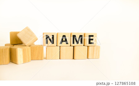 Name symbol. Concept word Name on beautiful wooden blocks. Beautiful white table white background. Business, lifestyle, support and name concept. Copy space. Name symbol. Concept word Name on beautiful wooden blocks. Beautiful white table white background. Business, lifestyle, support and name concept. Copy space. 127865108
