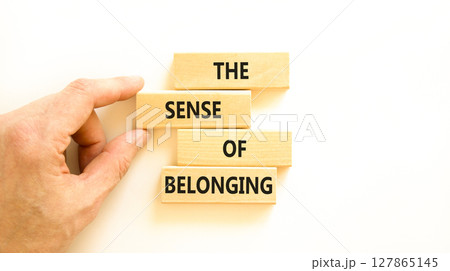 The sense of belonging symbol. Concept words The sense of belonging on beautiful wooden blocks. Beautiful white table white background. Business and the sense of belonging concept. Copy space. 127865145