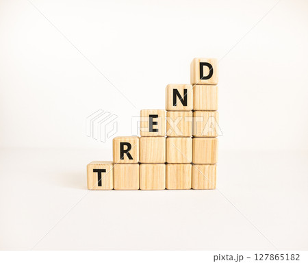 Trend and trending symbol. Concept word Trend on beautiful wooden blocks. Beautiful white table white background. Business lifestyle trend and trending concept. Copy space. Trend and trending symbol. Concept word Trend on beautiful wooden blocks. Beautiful white table white background. Business lifestyle trend and trending concept. Copy space. 127865182
