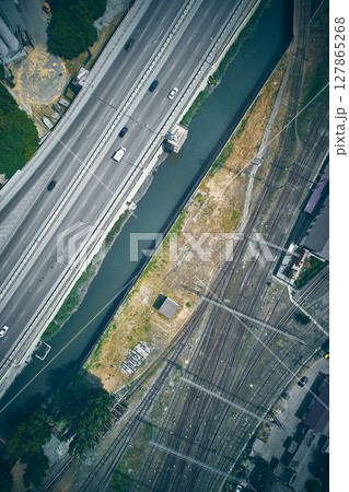 Aerial view of highway and railway intersection with canal 127865268