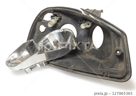parts of disassembled headlight. cracked black plastic housing and lights reflector. on white background, with clipping path 127865365