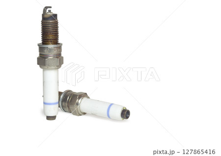 used spark plugs couple, blue strip on body of hite insulator. on white background, with clipping path 127865416