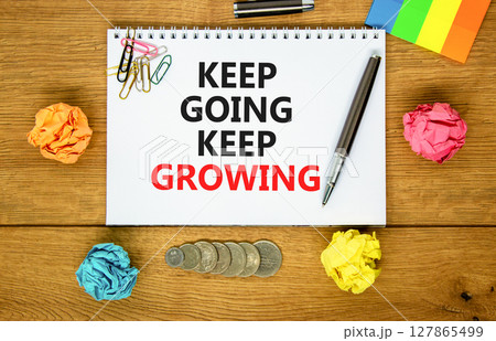 Keep going and growing symbol. Concept words phrase Keep going keep growing on beautiful white note. Colored paper. Beautiful wooden background. Business Keep going and growing concept. Copy space. Keep going and growing symbol. Concept words phrase Keep going keep growing on beautiful white note. Colored paper. Beautiful wooden background. Business Keep going and growing concept. Copy space. 127865499