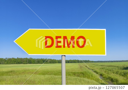 Demo symbol. Concept word Demo on beautiful yellow road sign. Beautiful blue sky green grass and forest peaceful nature background. Business and demo concept. Copy space. Demo symbol. Concept word Demo on beautiful yellow road sign. Beautiful blue sky green grass and forest peaceful nature background. Business and demo concept. Copy space. 127865507