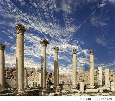 Roman Columns in the Jordanian city of Jerash (Gerasa of Antiquity), capital and largest city of Jerash Governorate, Jordan. Against the background of a beautiful sky with clouds Roman Columns in the Jordanian city of Jerash (Gerasa of Antiquity), capital and largest city of Jerash Governorate, Jordan. Against the background of a beautiful sky with clouds 127866426