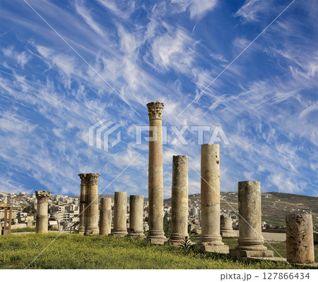 Roman Columns in the Jordanian city of Jerash (Gerasa of Antiquity), capital and largest city of Jerash Governorate, Jordan. Against the background of a beautiful sky with clouds Roman Columns in the Jordanian city of Jerash (Gerasa of Antiquity), capital and largest city of Jerash Governorate, Jordan. Against the background of a beautiful sky with clouds 127866434