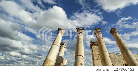 Roman Columns in the Jordanian city of Jerash (Gerasa of Antiquity), capital and largest city of Jerash Governorate, Jordan. Against the background of a beautiful sky with clouds Roman Columns in the Jordanian city of Jerash (Gerasa of Antiquity), capital and largest city of Jerash Governorate, Jordan. Against the background of a beautiful sky with clouds 127866452