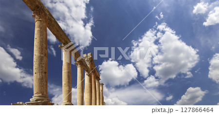 Roman Columns in the Jordanian city of Jerash (Gerasa of Antiquity), capital and largest city of Jerash Governorate, Jordan. Against the background of a beautiful sky with clouds Roman Columns in the Jordanian city of Jerash (Gerasa of Antiquity), capital and largest city of Jerash Governorate, Jordan. Against the background of a beautiful sky with clouds 127866464