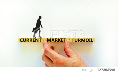 Current market turmoil symbol. Concept words Current market turmoil on wooden blocks on a beautiful white table white background. Businessman hand. Business, finacial current market turmoil concept. Current market turmoil symbol. Concept words Current market turmoil on wooden blocks on a beautiful white table white background. Businessman hand. Business, finacial current market turmoil concept. 127868596