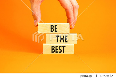Motivational be the best symbol. Concept words Be the best on beautiful wooden blocks. Beautiful orange background. Businessman hand. Business motivational be the best concept. Copy space. Motivational be the best symbol. Concept words Be the best on beautiful wooden blocks. Beautiful orange background. Businessman hand. Business motivational be the best concept. Copy space. 127868612