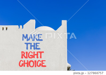 Make the right choice symbol. Concept words phrase Make the right choice on beautiful white wall. Beautiful white wall and blue sky background. Business Make the right choice concept. Copy space. 127868757