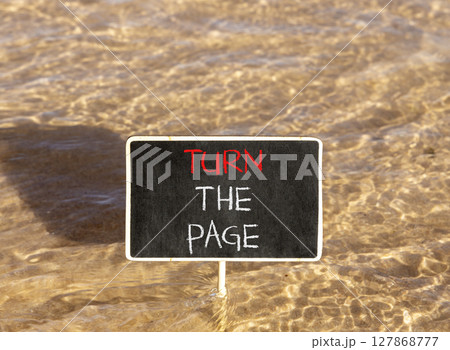 Turn the page symbol. Concept words Turn the page on beautiful blackboard. Beautiful Red sea water background. Business motivational lifestyle turn the page concept. Copy space. 127868777