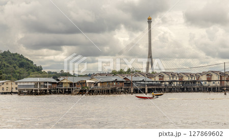 Motor boats and Kampong Ayer the floating village wooden Malay traditional houses standing on stilts on the river, Bandar Seri Begawan, Borneo, Sultanate Brunei Darussalam 127869602