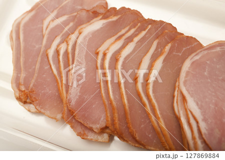 Ham cut into thin slices. 127869884