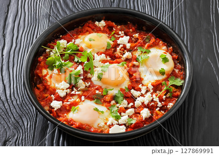 shakshuka, eggs poached in tomato vegetable sauce shakshuka, eggs poached in tomato vegetable sauce 127869991